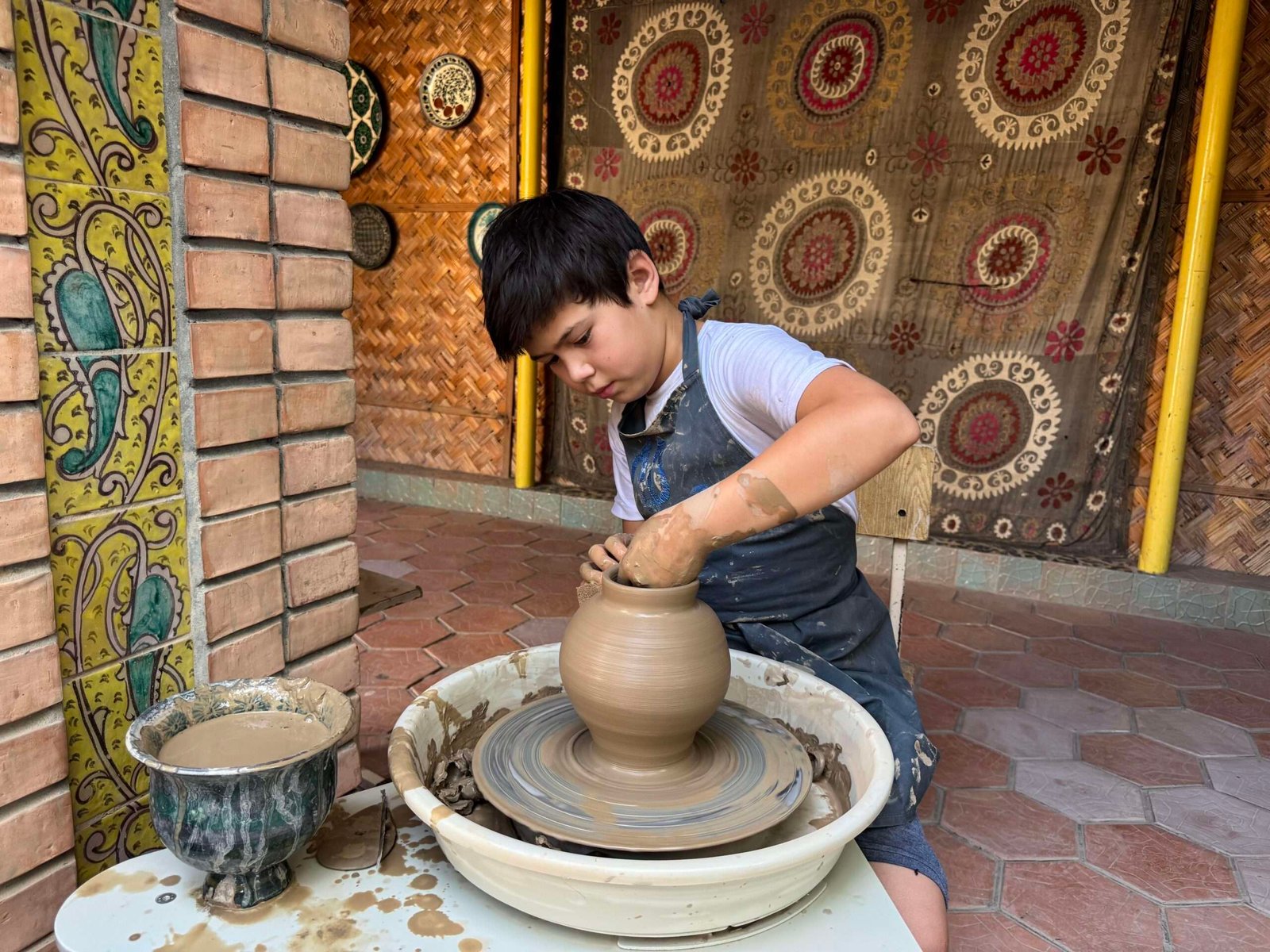An Uzbek artisan shaping handmade craftwork
